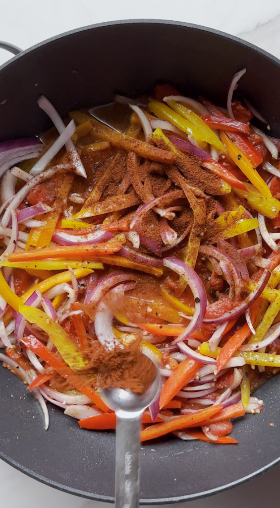 sliced bell peppers and onions and tomatoes, oil, garlic mixed together